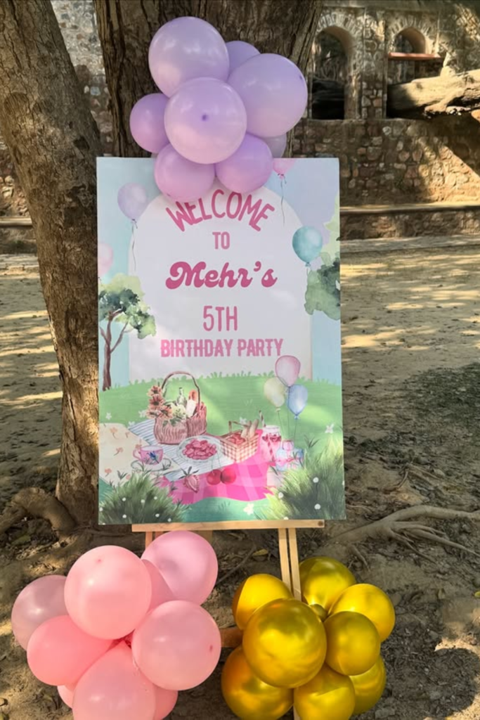 Colorful outdoor birthday welcome sign with balloons