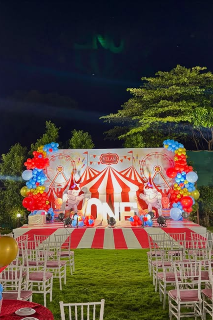 Illuminated circus birthday stage for an evening outdoor party