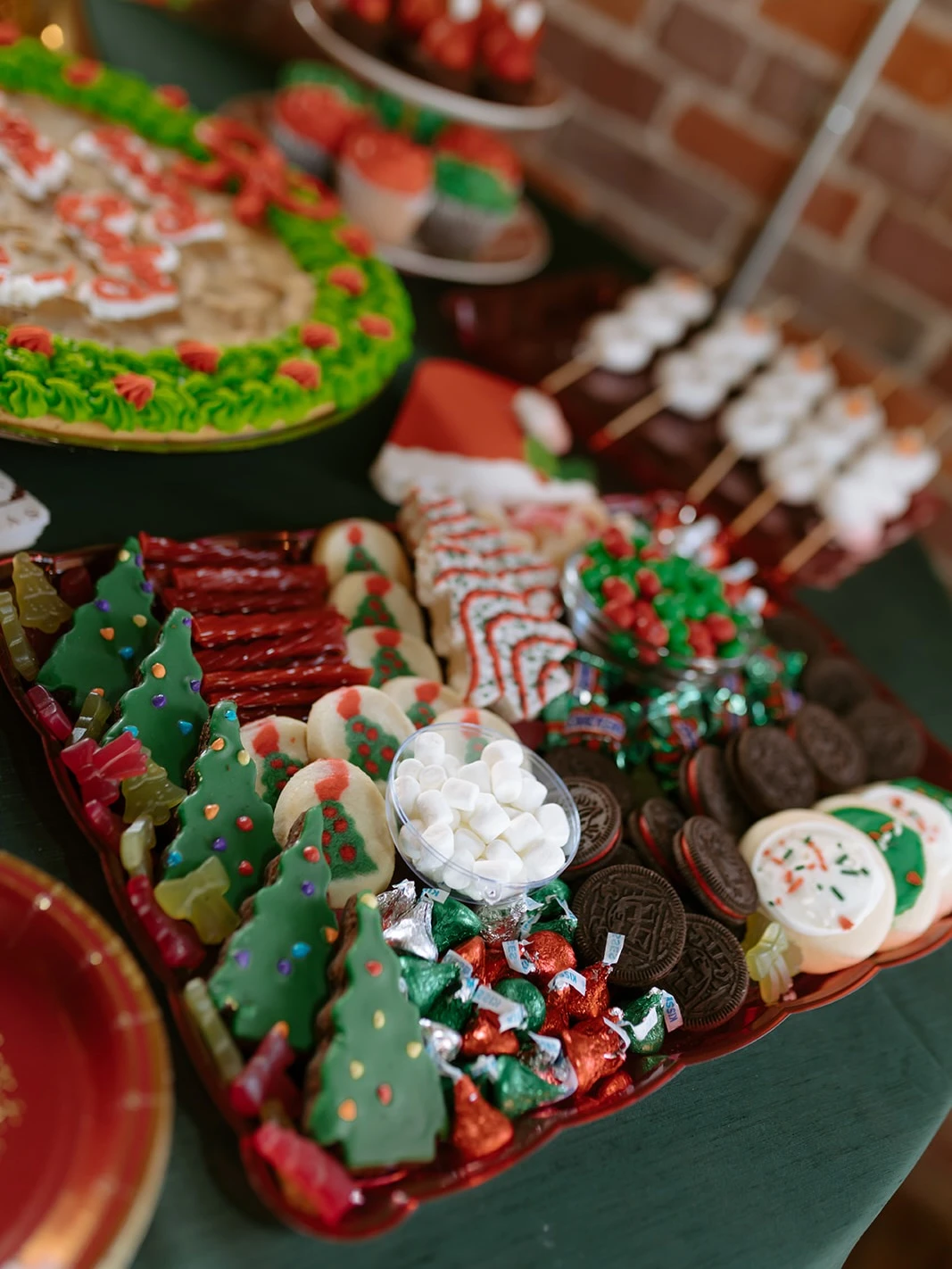 Holiday dessert buffet table with gingerbread cookies, tartlets, scones, and cookie jars