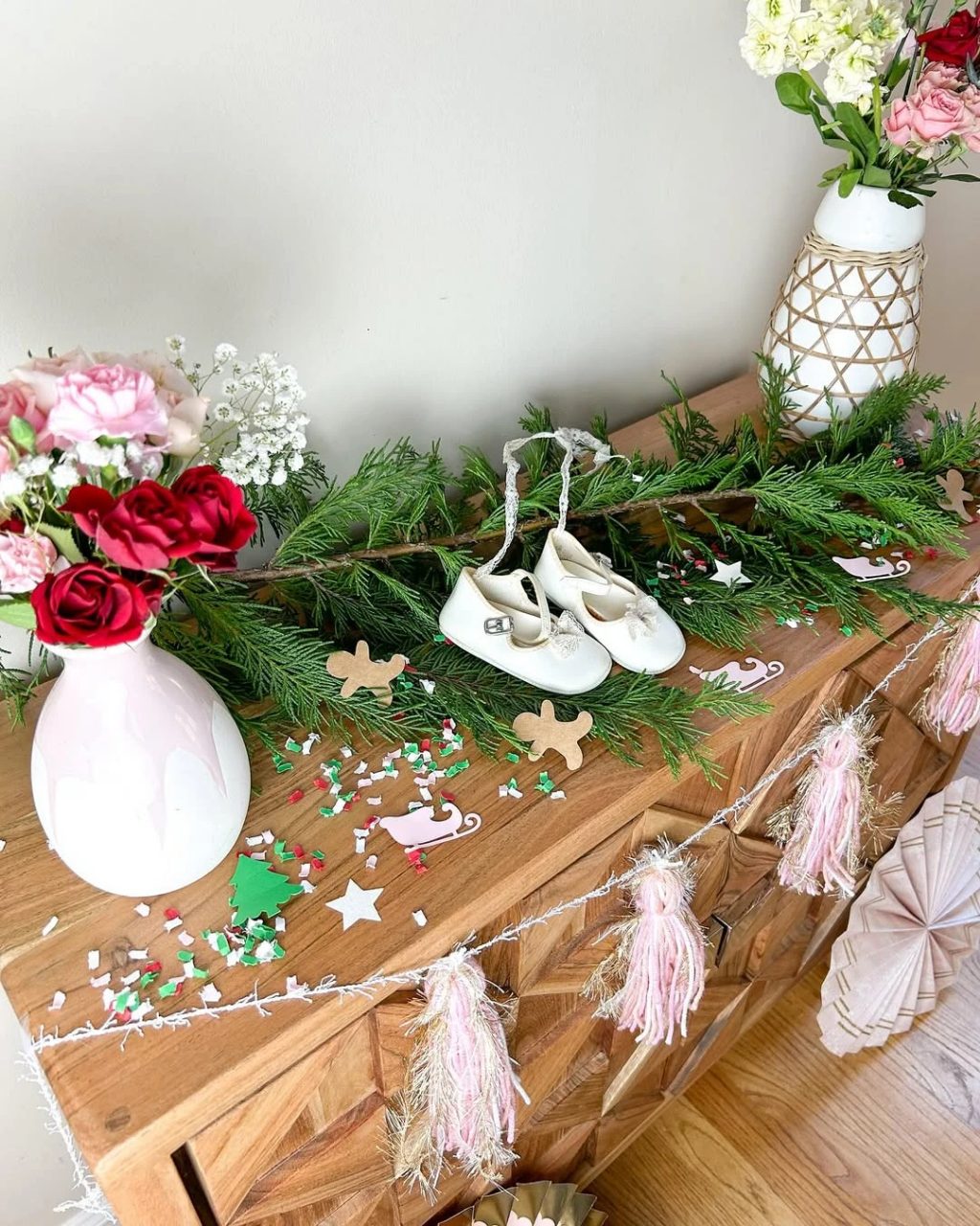 Vintage baby shoes and pine garland baby shower detail